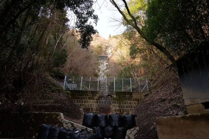 九十九折の舗装路を歩いて登っていきます。途中砂防ダム（？）のような建造物が見えてきました。どうやらさっき見えていた建造物はこれっぽい。